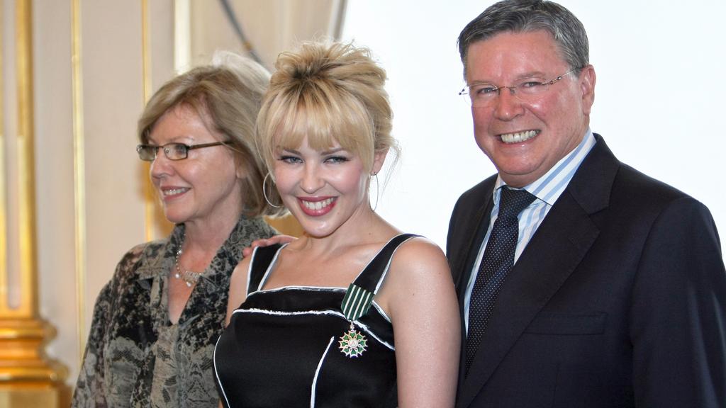 Australian pop star Kylie Minogue (c) poses with her parents after French Culture Minister awarded her as Chevalier of the Order of Arts and Letters (French Cultural distinction) 05 May 2008 in Paris, France. Minogue has sold more than 60 million records worldwide and overcame breast cancer, diagnosed in 2005, to return to performing.