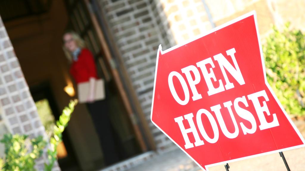 Realtor Opening Door at an Open House