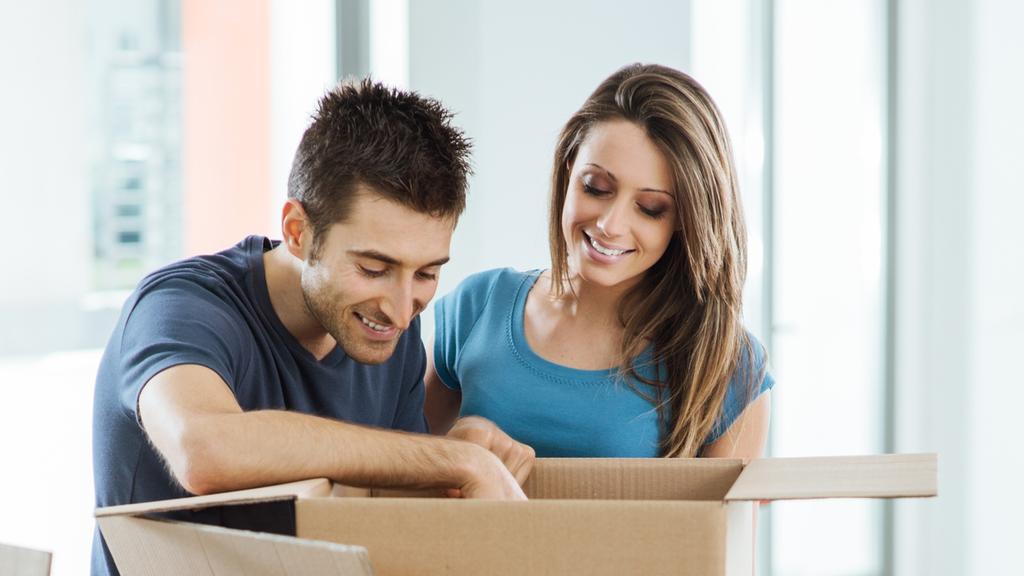 Smiling couple moving in a new house