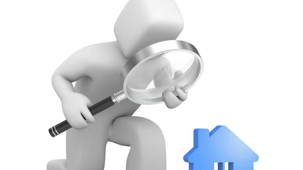 Person searching a new house. A figure looks at a house with a magnifying glass.