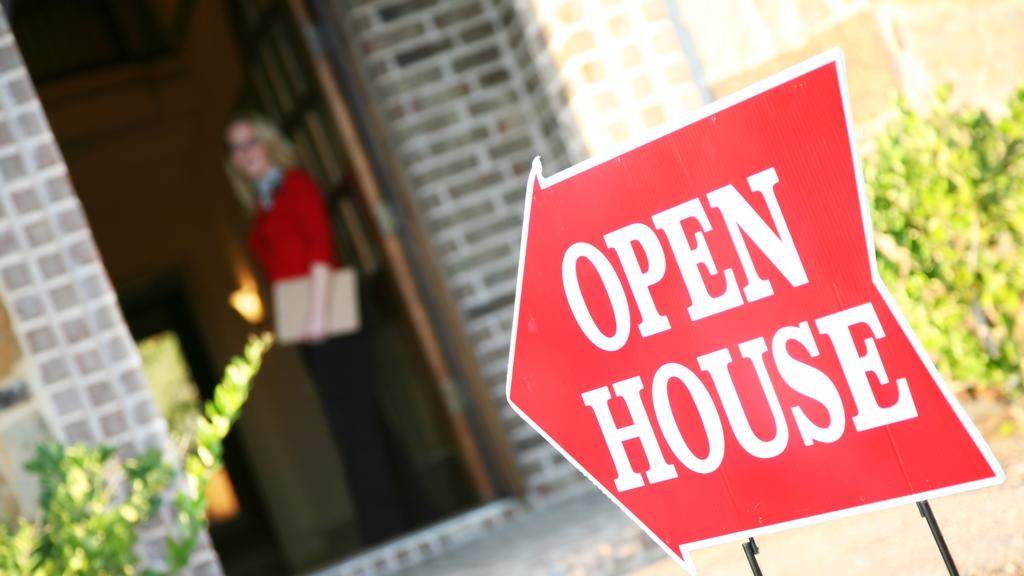 Realtor Opening Door at an Open House