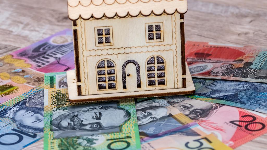 House model with australian dollar banknotes on table