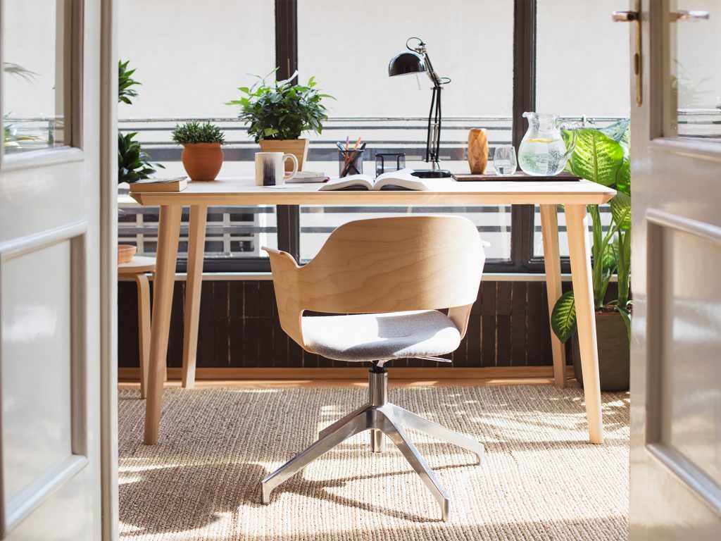 Office desk with wooden finish and plants